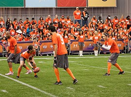 A group of Univision talent and ex-NFL players are pictured playing in the Tazon Latino flag football game, Thursday January 29, 2015, at the Phoenix Convention Center.